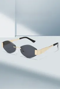 Close-up of frameless geometric diamond-cut lenses with gold metal temples and bridge