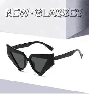 Detail view of modern black cat-eye sunglasses with geometric triangular frame