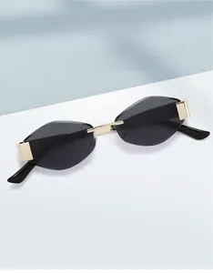 Detail of rimless vintage sunglasses featuring golden metal bridges and dark lenses