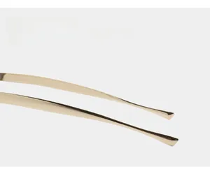 Detailed close-up of curved gold metal temples with smooth mirror finish and anti-slip design