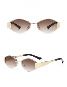Detail view of rimless geometric sunglasses with gold metal frame and gradient tea lenses