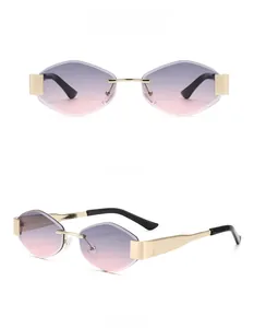 Close-up of rimless geometric sunglasses with gold metal frame and grey-pink gradient lenses