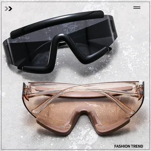Close-up of oversized wraparound cycling sunglasses in black and translucent tawny colors