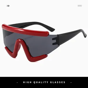 Detail of red oversized sports sunglasses with large grey one-piece lenses and V-shape bridge