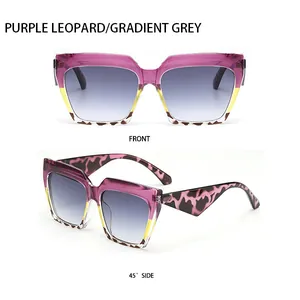 Detail view of cat-eye sunglasses featuring purple and leopard print frames with grey lenses