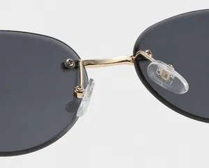 Detail of eco-friendly nose pads and gold metal bridge on rimless sunglasses