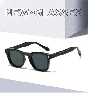 Detailed view of black square frame sunglasses with silver diamond rivets and polished finish