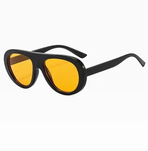 Detail view of vintage aviator sunglasses with black frame and vibrant orange lenses