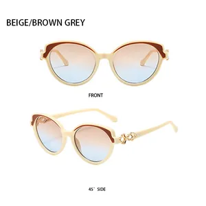 Detail of beige cat-eye sunglasses with gradient lenses and gold woven metal hinges