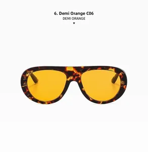 Detailed close-up of retro aviator sunglasses in demi frame with vibrant orange lenses