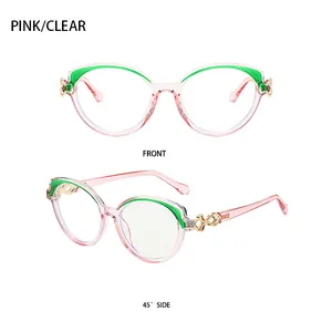 Macro view of pink cat-eye eyeglass frame with green detail and gold infinity hinge