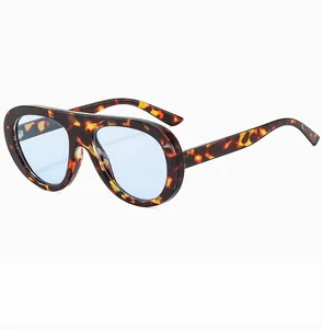 Detail view of retro pilot sunglasses with tortoise frames and blue tinted lenses
