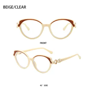 Detail view of beige cat-eye sunglasses with gold infinity accents and brown color blocks