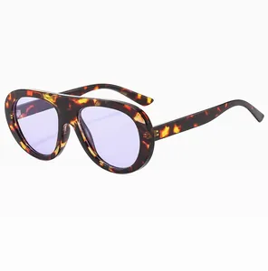 Detail of retro tortoiseshell frame sunglasses with gradient purple lenses at 45-degree angle