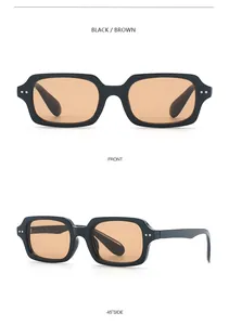 Close-up of retro rectangle sunglasses with black frame, brown lenses and metal rivets