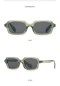 Detail of retro green rectangle sunglasses with silver rivets and dark lenses