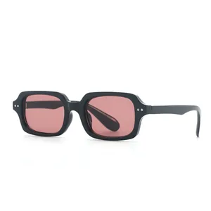 Retro square sunglasses with thick black frame, silver rivets, and red tinted lenses