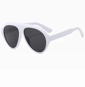 Close-up of white oversized frame sunglasses with seamless dark grey lenses for women