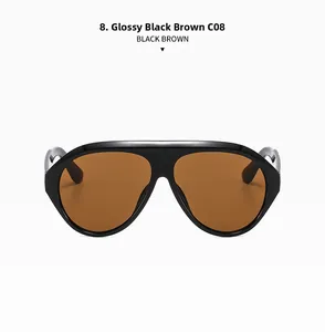 Detail view of large shiny black frame sunglasses with solid brown lenses and thick bridge