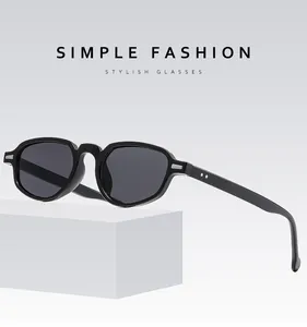 Retro cat-eye sunglasses with black frame and grey lenses on minimalist display stand