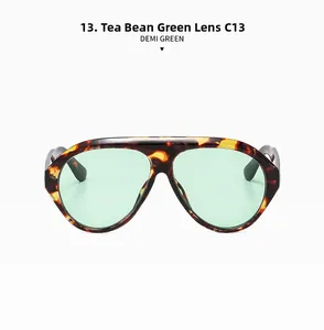Detail of oversized tortoise frame sunglasses with green lenses and C13 marking