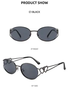 Details einer schwarzen ovalen Sonnenbrille mit herzförmigem Ausschnitt am Metallbügel