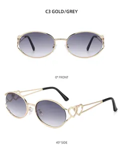 Details von Gold Metall Sonnenbrille mit Herz Ausschnitt Design und grauen Gläsern
