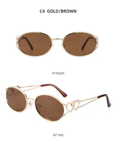 Detail der goldenen Sonnenbrille mit braunen Gläsern und herzförmigem Bügeldesign