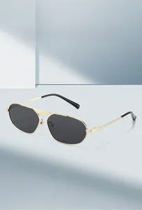 Detail of pilot metal sunglasses with gold irregular frames and dark gray lenses
