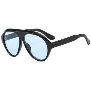 Oversized black frame sunglasses with light blue lenses for a stylish vacation look