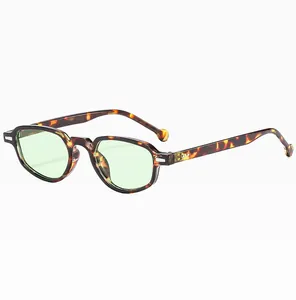 Macro detail of retro cat eye sunglasses featuring leopard print frame and green lenses