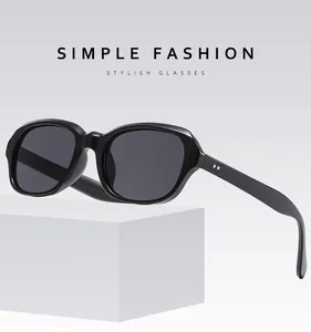 Detail showing silver rivet accents on bold black square frames of stylish sunglasses