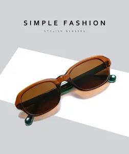 Detail of square amber tortoiseshell frames with dark lenses and green temple tips