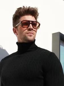 Close-up of tortoise shell aviator sunglasses with brown gradient lenses on male model