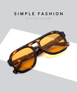 Detail of tortoise frame sunglasses with orange lenses and hollow double bridge design