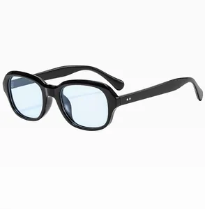 Detail view of retro square black frames with light blue lenses and silver metal rivets