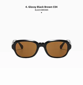 Detailed close-up of shiny black rectangular frame sunglasses with tea brown lenses