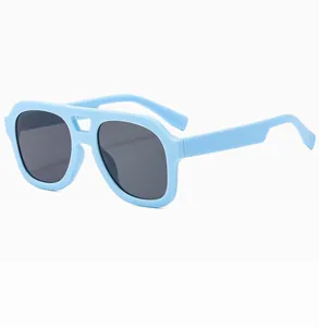 Detail of light blue double-bridge sunglasses with dark grey lenses and wide frames