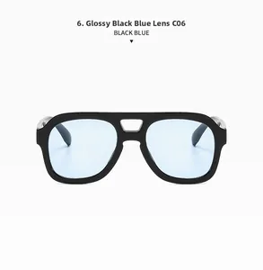 Detail of glossy black double-bridge sunglasses with transparent light blue lenses