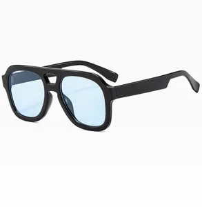 Close-up of stylish double bridge aviator sunglasses with light blue lenses and black frames