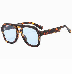 Detail of tortoise frame aviator sunglasses with blue lenses and a double bridge design