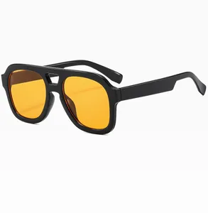 Detail of vintage double-bridge sunglasses with black frame and orange lenses