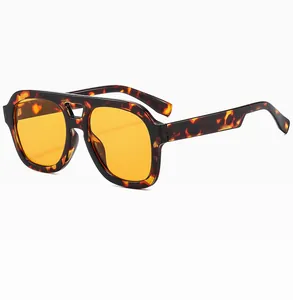 Detail view of double bridge aviator sunglasses with tortoise frame and orange lenses