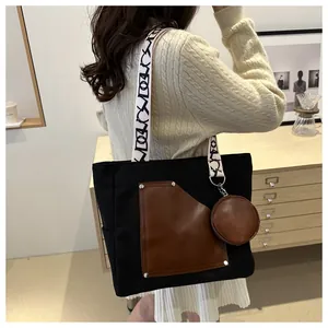 Large capacity canvas commuter tote bag with brown leather patchwork and graphic straps