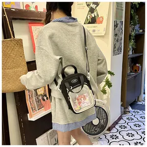 Detail view of the cute black canvas crossbody bag with transparent mesh pocket and strap.