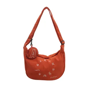 Orange corduroy crescent tote bag with detachable coin purse and white embroidery