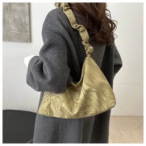 Back view of a model wearing a green marble pattern tote bag with ruffled shoulder straps