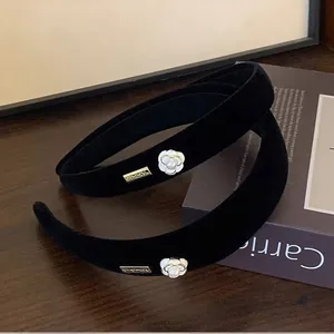 Cerchietto elegante in velluto nero con camelia bianca e targhetta in oro