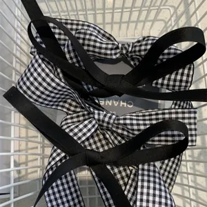 Chic black and white houndstooth bow hair clips set with elegant vintage fabric texture