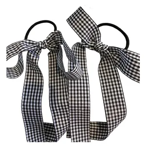 Set of two black and white plaid bow hair ties for elegant ponytail styling